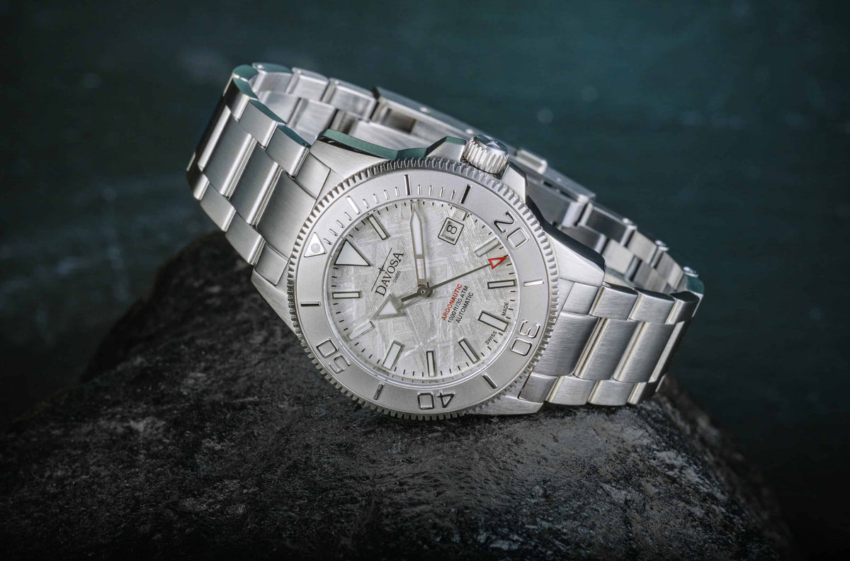 Davosa Argonautic Meteorite 161.544.10 resting on dark rock, showing the meteorite dial, dive bezel and WaveSlide bracelet